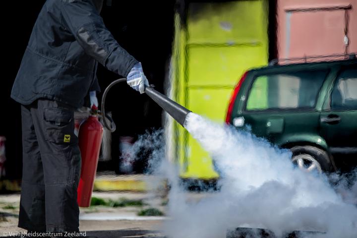 Cursist blust met een CO2-blusser